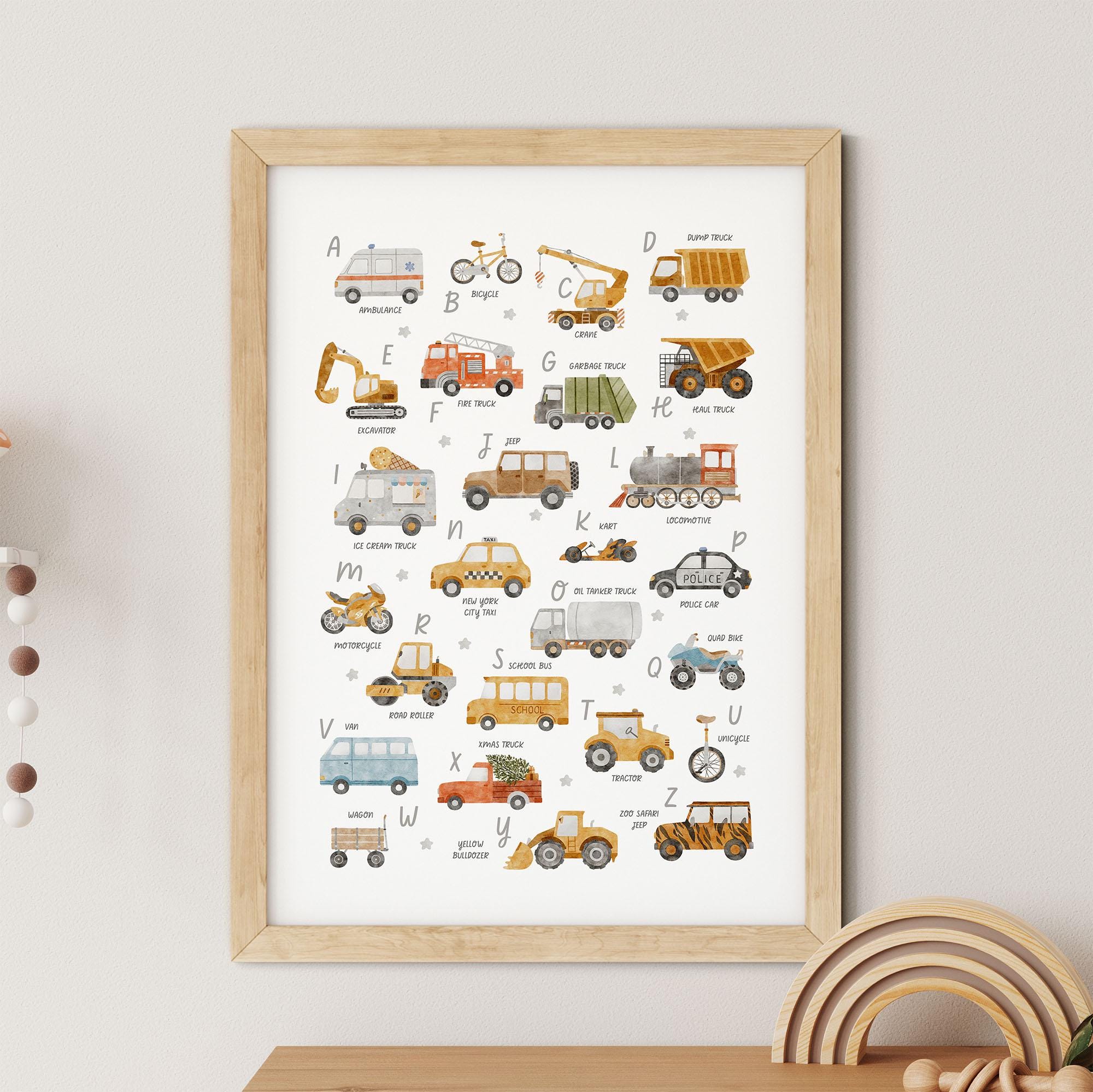 Framed poster featuring an illustrated A-Z of different vehicles, each letter paired with a corresponding vehicle, displayed on a light-colored wall above a wooden toy and beads.