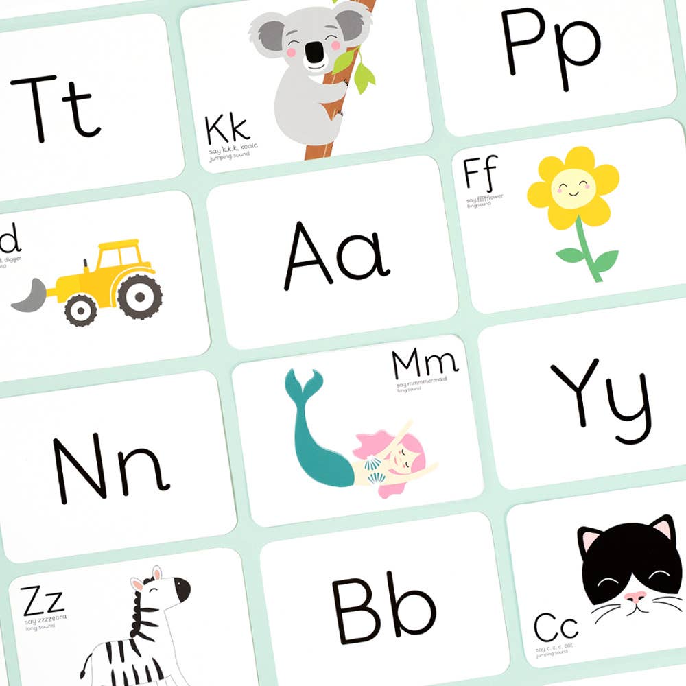 Priya & Peanut Phonic Flash Cards feature playful illustrations of uppercase and lowercase letters—like a koala, flower, tractor, mermaid, cat, and zebra—on a light green background, perfect for learning phonics.