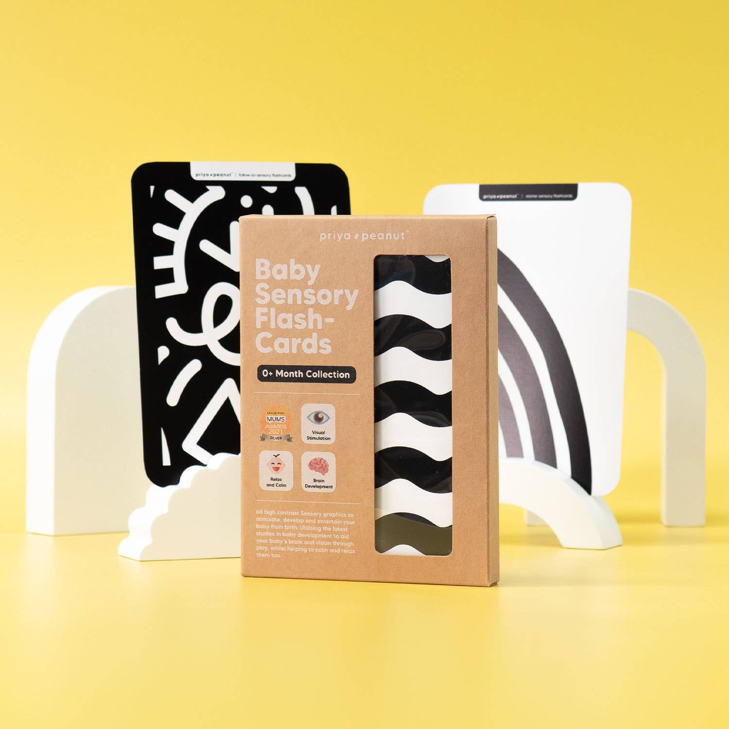 A box of Priya & Peanut Newborn Sensory Cards (0+ Months Old) | Award-Winning Baby Toy stands on a yellow background, with high contrast cards on white stands. Bold text and icons support baby's visual development.