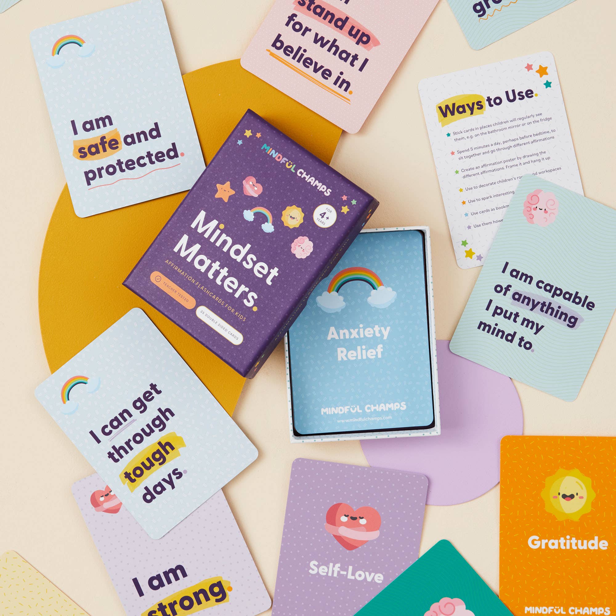 Mindful Champs’ Mindset Matters Flashcards are spread around an open box, featuring positive phrases like "I am safe and protected" to boost self-esteem and encourage a growth mindset.
