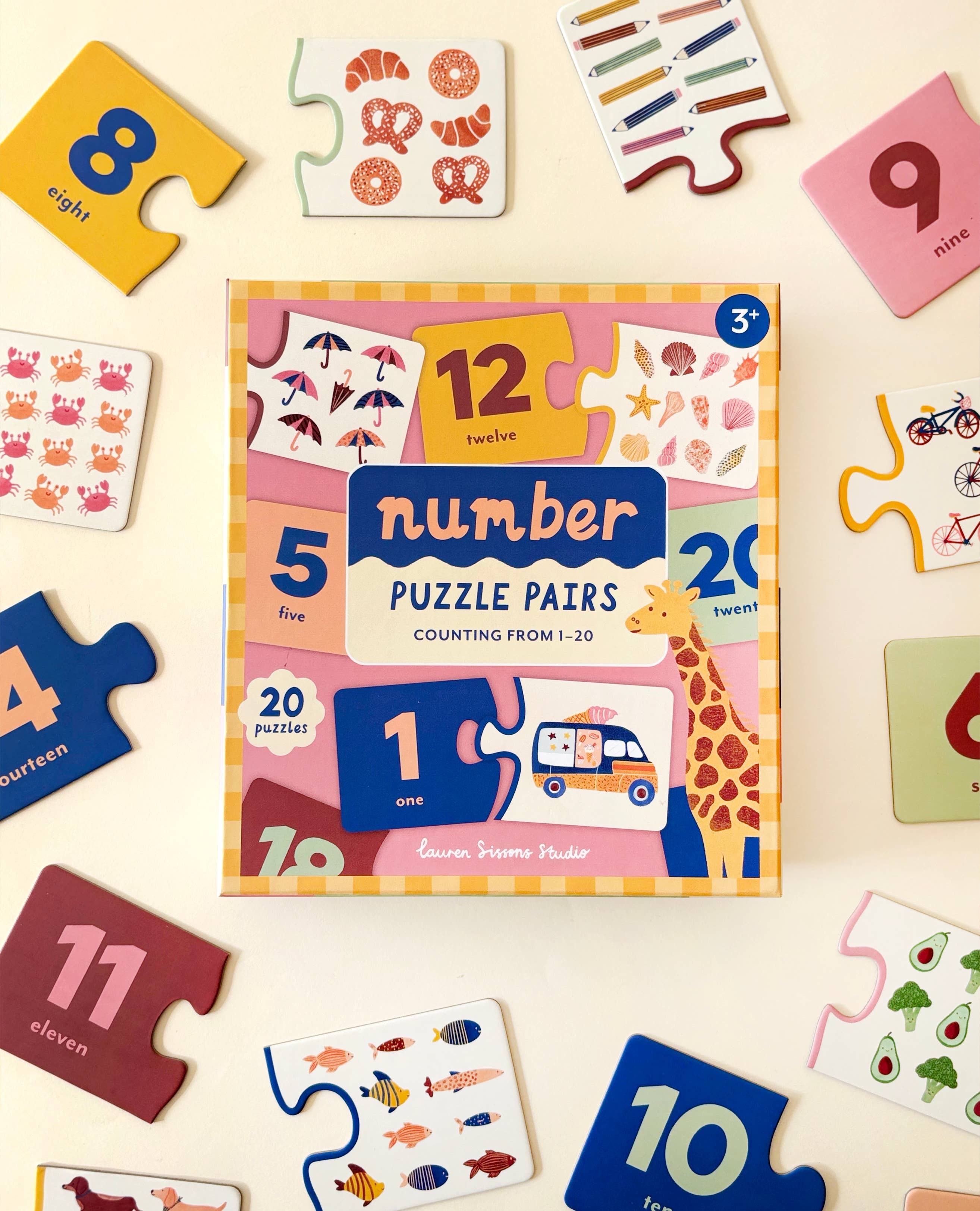 The Lauren Sissons Studio Number Puzzle Pairs - Kids Toys Learning Game Educational features animal illustrations, number cards, and puzzle pieces to help children learn numeracy and counting skills with numbers and objects from 1 to 20.