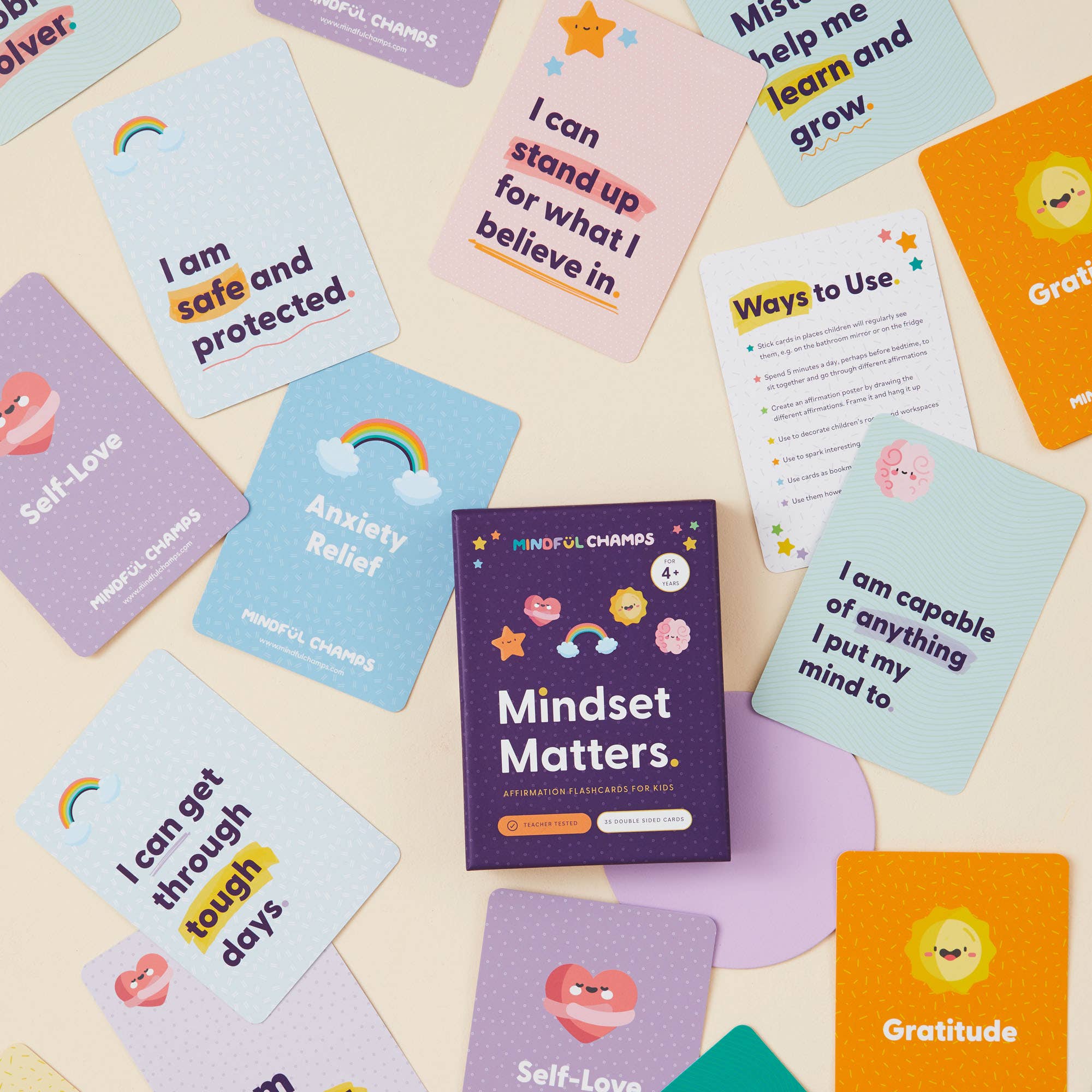 Mindful Champs’ Mindset Matters Flashcards are colorful cards for kids, displayed around a purple box. Each card inspires a growth mindset, featuring positive messages such as “I am safe and protected” and “Gratitude.”.