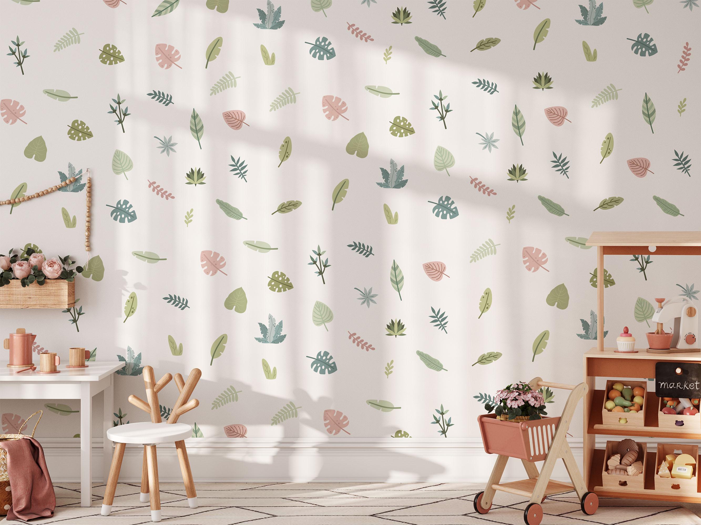 A bright, cozy childrens room features a lively floral wallpaper enhanced with Tropical Leaves Nursery Wall Stickers by My Store. It includes a white chair, a mini market stand with plants, and a basket of toys. Sunlight dances across the vibrant walls and wooden floor.