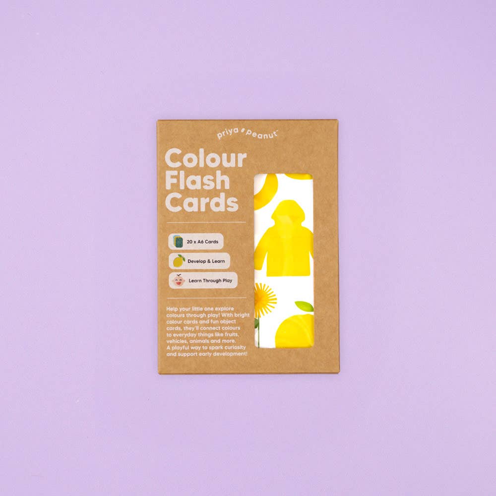A brown cardboard package labeled "Priya & Peanut Colour Flash Cards" for early learning, features a window displaying a yellow card with lemons and a raincoat, set on a light purple background.
