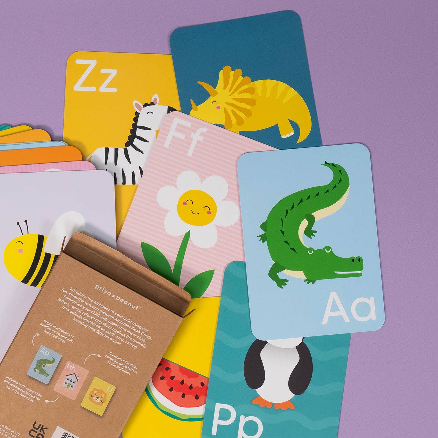 Priya & Peanut’s Alphabet Flash Cards | Learn The Alphabet Easily feature colorful animal and object illustrations, making learning fun for kids—all displayed on a vibrant purple surface.