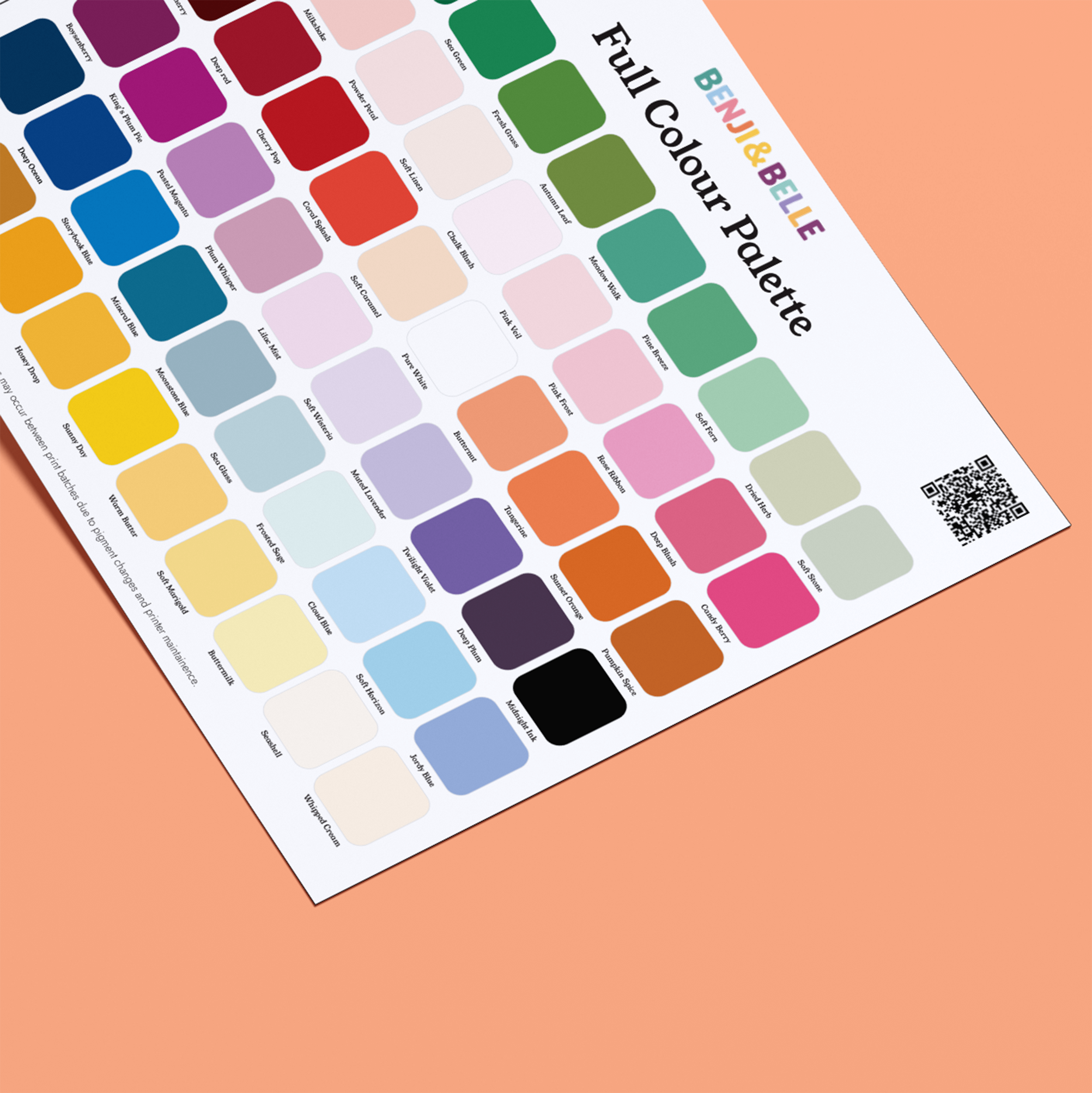 A printed Wallpaper Colour Sample chart by Benji & Belle displays dozens of color swatches with the title “Full Colour Palette” on a peach background, QR code, and the Benji & Belle label at the top right.