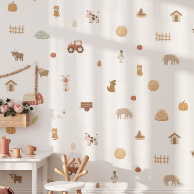 A bright nursery with a small white table and pink flowers is decorated with Baby Belle’s On The Farm Wall Decals, featuring playful animals, a tractor, barn, eggs, pumpkins, hay bales, and fences.