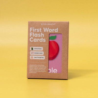 A brown Priya & Peanut First Word Flash Cards box stands on a yellow background. Featuring 50 first words for toddlers, the box’s window reveals an apple card—perfect for learning, play, and speech development.
