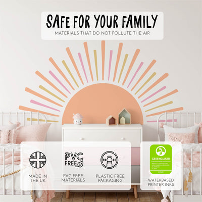 A childrens bedroom features the Boho Sun Sticker by My Store, a UK-made, PVC-free, plastic-free wall decal using water-based inks and Greenguard certified. It adorns a white dresser beside two beds with pink bedding.