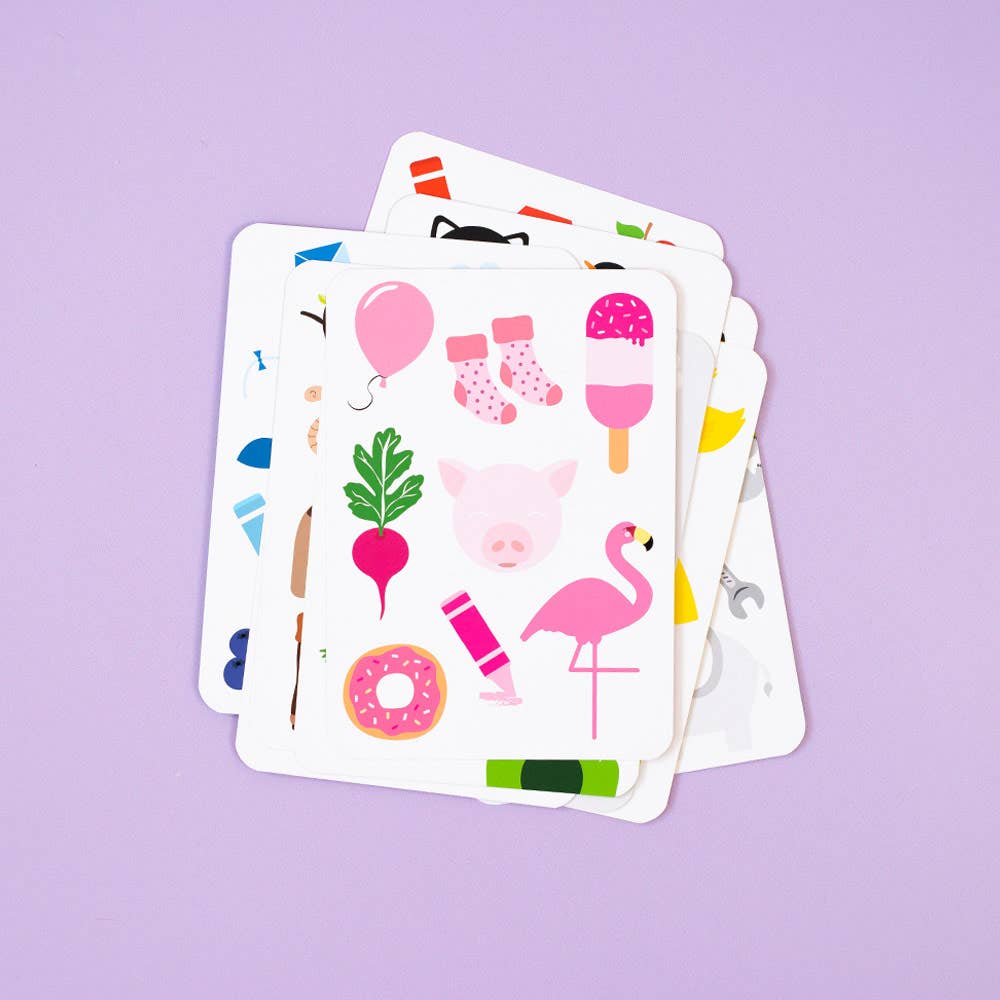 Priya & Peanut Colour Flash Cards for toddlers shown on a purple background, with the top card featuring pink items like a balloon, socks, popsicle, pig, beet, flamingo, crayon and donut—an ideal early learning tool.