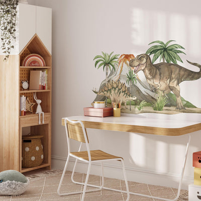 A childrens room features a modern desk and chair set against a wall adorned with My Stores Dinosaur Nursery Stickers. A house-shaped wooden shelf holds books and toys, while playful nursery decor accents the space basked in natural light.