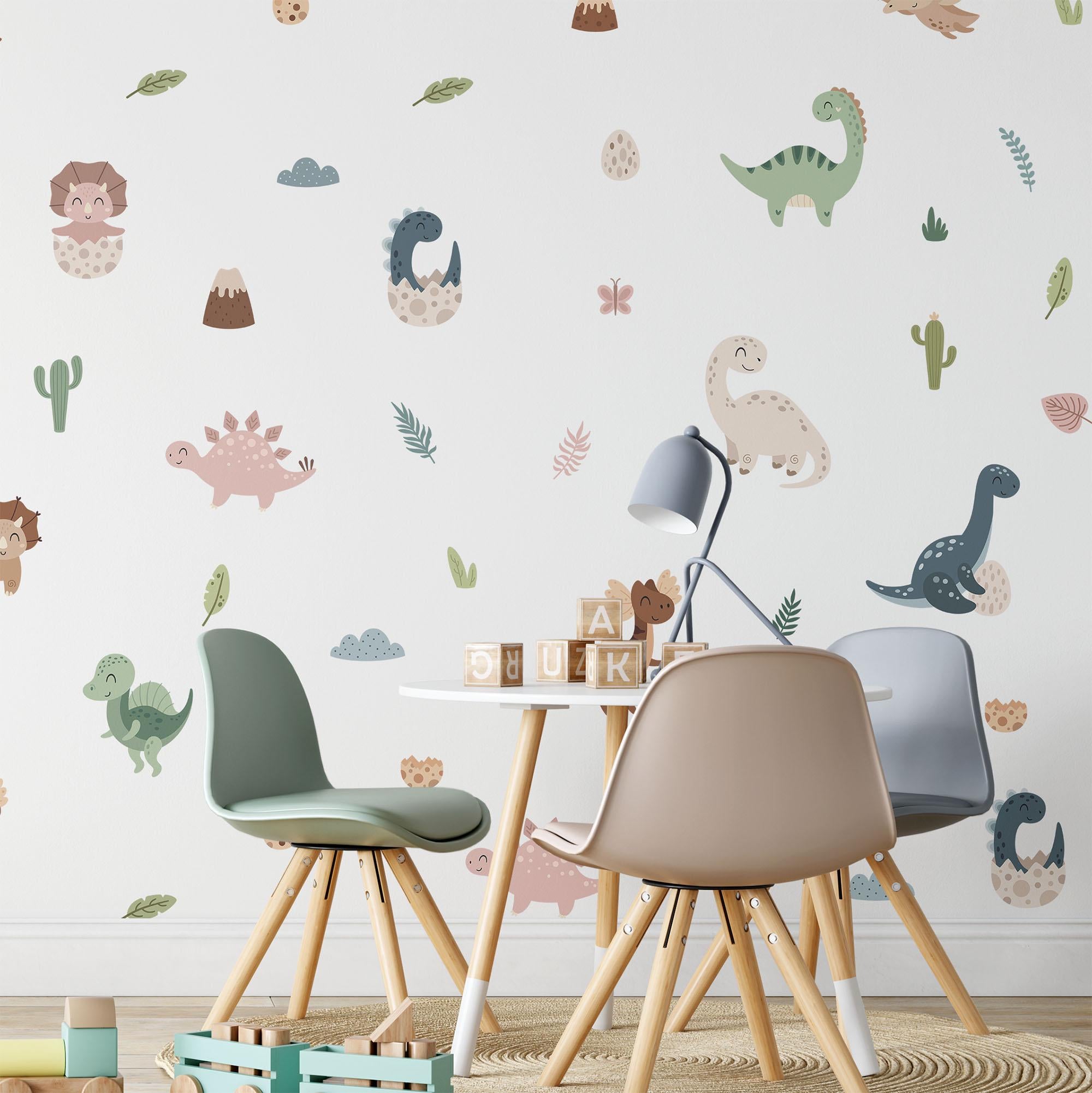 A childrens room comes alive with My Stores Fun Dinosaurs Stickers. Three chairs circle a small table with colorful wooden blocks beneath a gray desk lamp. The playful decor in green, brown, and beige employs removable self-adhesive decals for easy updating.