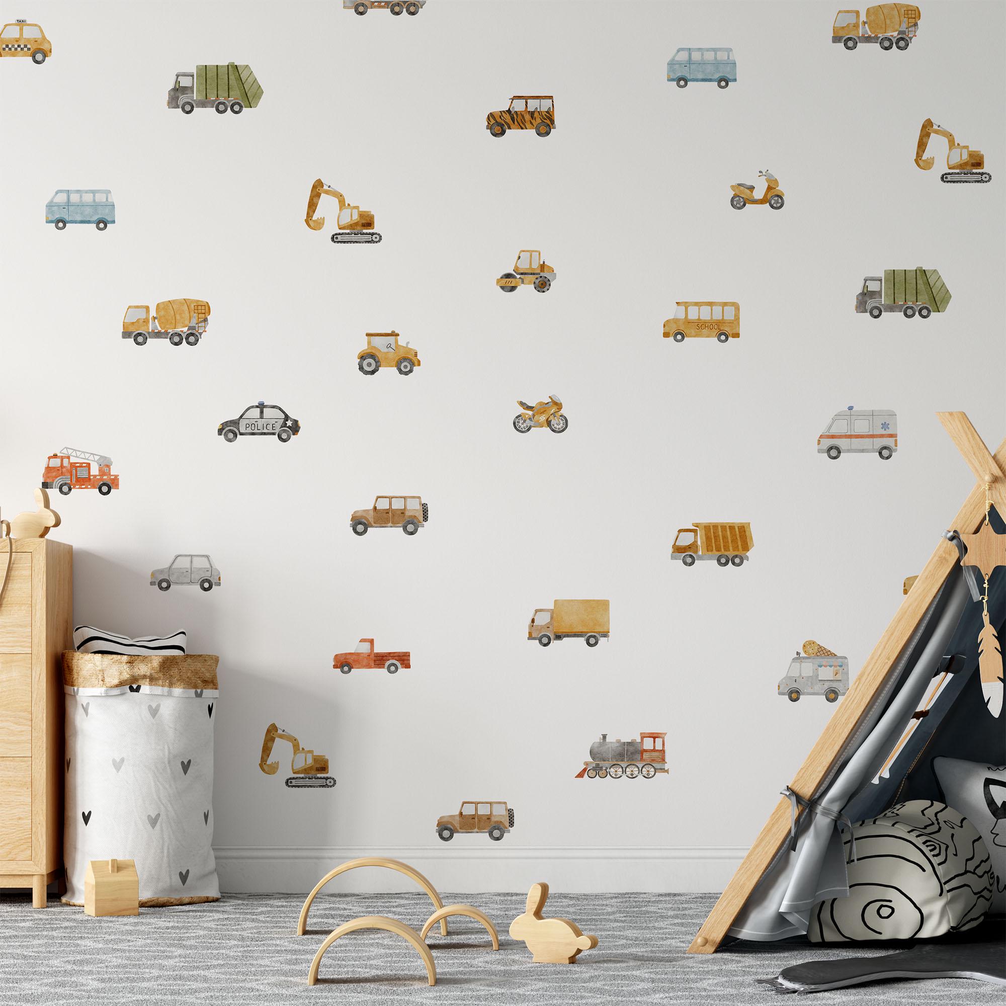 In a childrens room, My Stores Transport Vehicles Wall Stickers adorn a white wall with cars, trucks, and buses, complemented by a teepee in the corner. A toy basket and wooden toys are scattered on the floor.