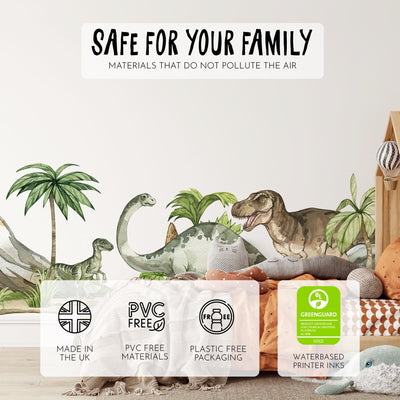 A childrens room features My Stores Dinosaur Nursery Stickers, including a T-rex and long-neck dinosaur. The cozy bed is surrounded by stuffed animals and cushions. Labels showcase eco-friendly features: PVC-free, plastic-free, and Greenguard certified.