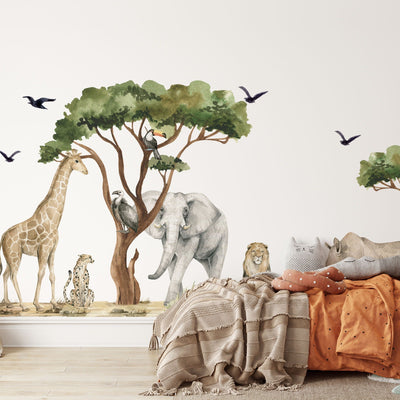 A childrens room features My Stores Safari Animals Nursery Stickers, depicting a watercolour giraffe, cheetah, tree, elephant, lion, and birds. A cozy bed with brown and orange bedding completes the warm setting.