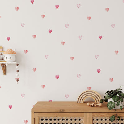 A room featuring Watercolour Heart Stickers from My Store, a small wall shelf with mushroom decor, and a wooden cabinet adorned with a plant and rainbow decor.