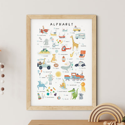 The Numbers & Alphabet Nursery Print by My Store is a framed poster featuring illustrated animals and objects for each letter, from A to Z, including playful drawings like a giraffe, xylophone, and zebra. Its an educational piece that hangs above wooden toys on a light-colored wall.